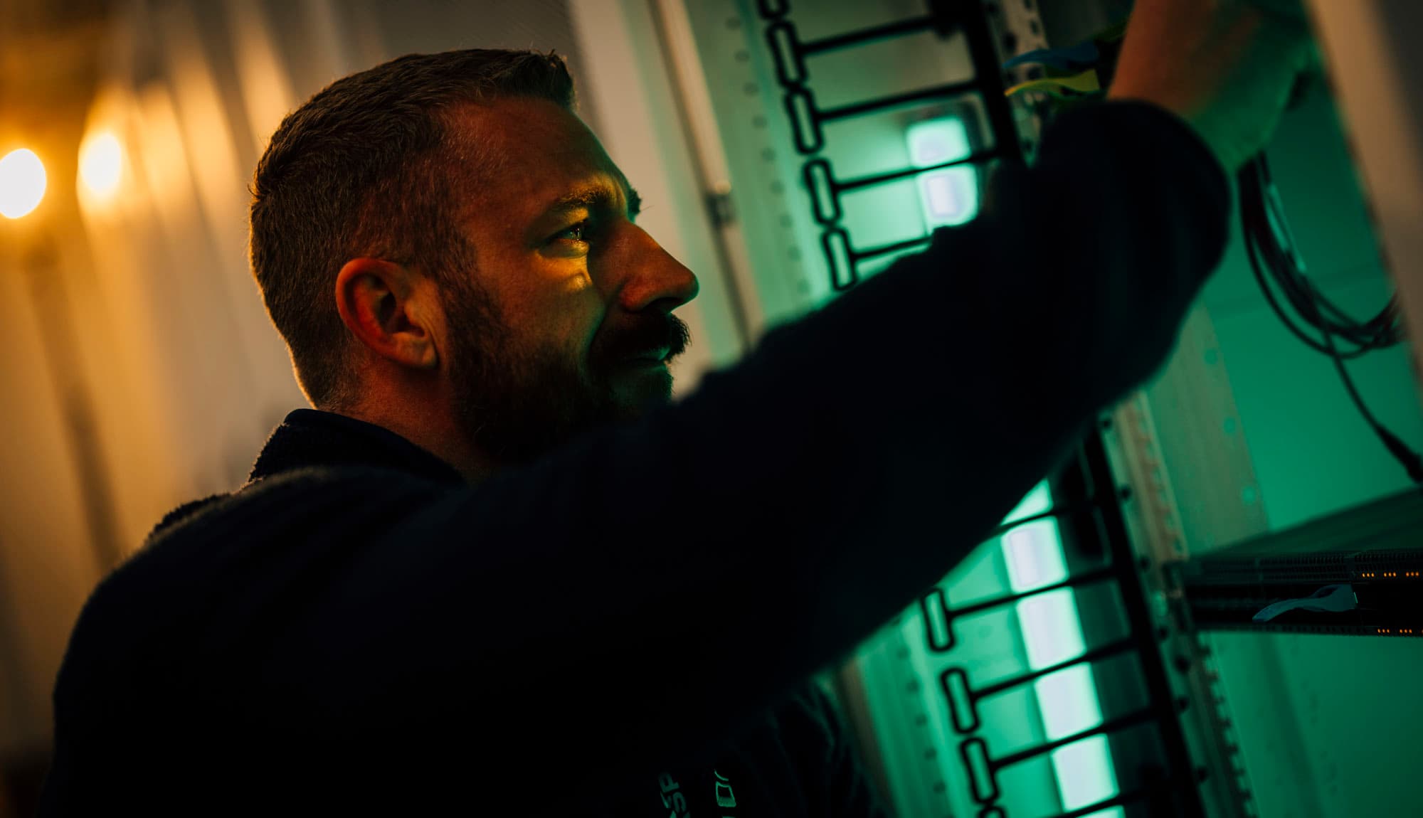 Technician working on a server rack inside an ASP data center