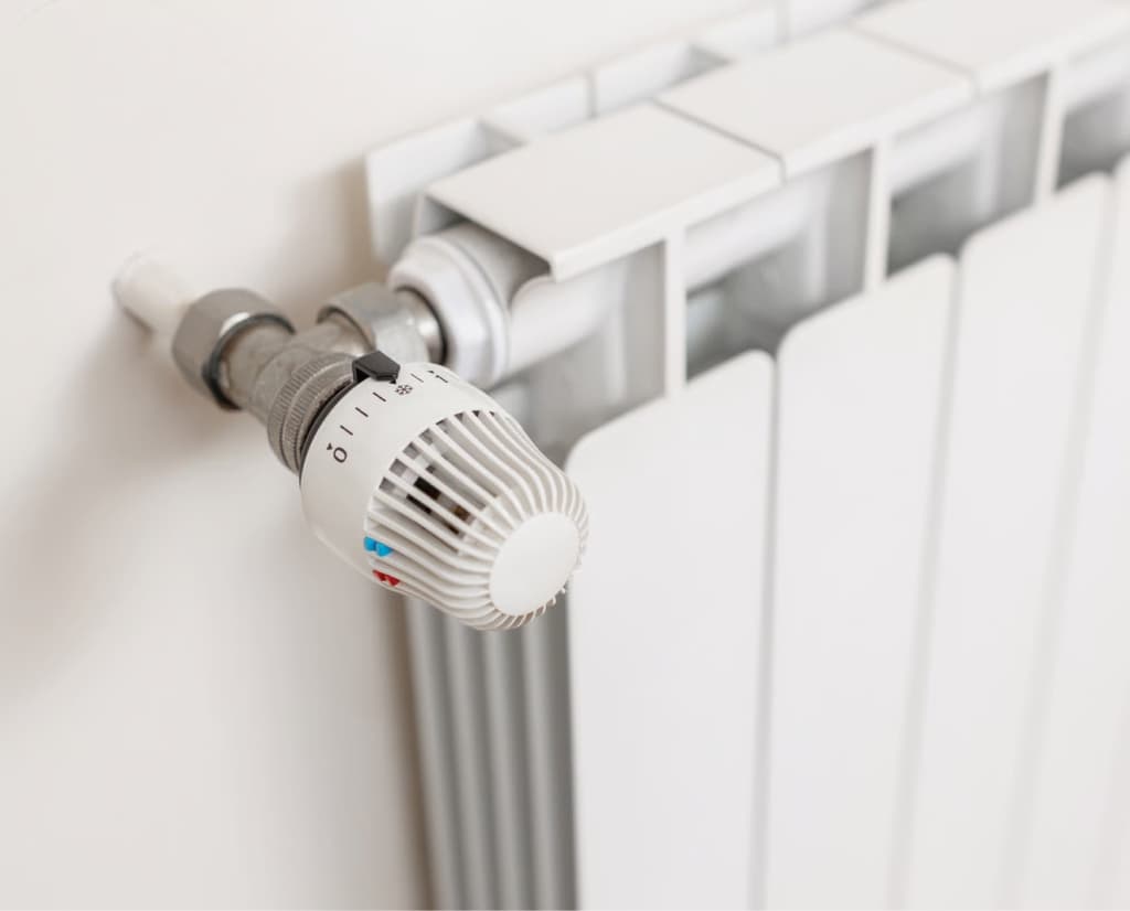 Thermostat valve on a white radiator